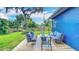 Spacious backyard featuring a deck with outdoor seating around a firepit and lush green lawn at 1202 Chichester St, Orlando, FL 32803
