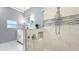 Modern bathroom featuring a glass-enclosed shower with mosaic tile and a sleek vanity with storage at 1202 Chichester St, Orlando, FL 32803