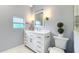 Bathroom features a white vanity with elegant fixtures and a classic design for a serene experience at 1202 Chichester St, Orlando, FL 32803