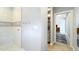 Bright bathroom featuring a tiled shower with a decorative mosaic accent wall, hooks, and a view to the bedroom at 1202 Chichester St, Orlando, FL 32803
