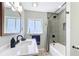 Well-lit bathroom with a large mirror, vanity, and a tub/shower combination, showcasing a clean and modern design at 1202 Chichester St, Orlando, FL 32803