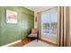 Inviting bedroom showcasing a green accent wall, closet with an orange throw pillow in a vintage chair at 1202 Chichester St, Orlando, FL 32803