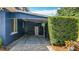 Carport and side view of the house, complimented by brick pavers and lush landscaping at 1202 Chichester St, Orlando, FL 32803
