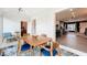 Dining area with a rustic table and seating with a view into other spaces in the house at 1202 Chichester St, Orlando, FL 32803