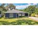 Charming single-story home with well-maintained lawn, tidy landscaping, and attached carport at 1202 Chichester St, Orlando, FL 32803