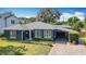 Beautiful house showcasing lush landscaping, a charming front yard, and convenient covered carport at 1202 Chichester St, Orlando, FL 32803