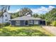 Charming home showcasing a manicured front yard with lush landscaping and a covered carport at 1202 Chichester St, Orlando, FL 32803