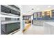 Modern kitchen boasts built-in stainless steel appliances, gray cabinets, and access to the living area at 1202 Chichester St, Orlando, FL 32803