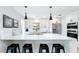 Modern kitchen with black pendant lights, a white countertop island, and stainless steel appliances at 1202 Chichester St, Orlando, FL 32803