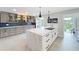 Open concept kitchen with a marble island, gray cabinets, blue backsplash, and backyard access at 1202 Chichester St, Orlando, FL 32803
