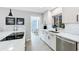 Modern kitchen with white cabinetry, stainless steel appliances, and marble countertops at 1202 Chichester St, Orlando, FL 32803