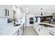 Spacious kitchen featuring white cabinets, marble countertops, stainless steel appliances, and an open layout to the living area at 1202 Chichester St, Orlando, FL 32803