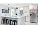 Bright kitchen features a white marble island, stainless steel appliances, and modern pendant lighting at 1202 Chichester St, Orlando, FL 32803