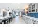 Bright kitchen leading to a living room, with custom cabinets, subway tile backsplash, and stainless appliances at 1202 Chichester St, Orlando, FL 32803