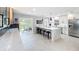 Open kitchen boasts a marble island with bar seating, stainless steel appliances, and backyard patio access at 1202 Chichester St, Orlando, FL 32803