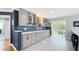 Modern kitchen features gray cabinets, blue subway tile backsplash, and white countertops at 1202 Chichester St, Orlando, FL 32803