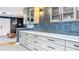 Bright kitchen with light-colored cabinets, long drawers and blue tile backsplash at 1202 Chichester St, Orlando, FL 32803