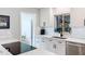 Bright kitchen featuring white cabinets, black hardware, stainless steel sink, and view to backyard at 1202 Chichester St, Orlando, FL 32803