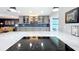 Bright open concept kitchen featuring gray cabinetry with glass fronts and marble countertops at 1202 Chichester St, Orlando, FL 32803