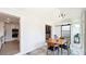 Sunroom with dining area, sliding glass doors to backyard, and open layout to the kitchen at 1202 Chichester St, Orlando, FL 32803
