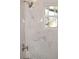 Beautifully renovated bathroom with marble tiling and modern fixtures, creating a luxurious spa-like experience at 1518 Indiana St, Orlando, FL 32805