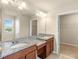 Bathroom with double vanity, granite countertops, tiled flooring and large mirror at 16043 Pebble Bluff Loop, Winter Garden, FL 34787