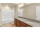Bathroom with double vanity, granite countertops, tiled flooring and combination tub and shower at 16043 Pebble Bluff Loop, Winter Garden, FL 34787