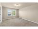 Carpeted bedroom with two windows allowing plenty of natural light at 16043 Pebble Bluff Loop, Winter Garden, FL 34787
