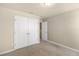 Carpeted bedroom featuring a closet and a view from the window at 16043 Pebble Bluff Loop, Winter Garden, FL 34787
