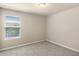 Bedroom with a carpeted floor and large window overlooking neighborhood at 16043 Pebble Bluff Loop, Winter Garden, FL 34787