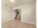 Spacious, empty room featuring tile flooring, neutral walls, and view to stairs at 16043 Pebble Bluff Loop, Winter Garden, FL 34787