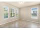 Bright, empty room featuring tile flooring, neutral walls, and multiple windows with blinds at 16043 Pebble Bluff Loop, Winter Garden, FL 34787
