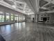 Large event space with hardwood floors, chandeliers, and plenty of natural light at 16043 Pebble Bluff Loop, Winter Garden, FL 34787