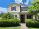 Charming two-story home showcasing verdant landscaping, shrubs, and a brick walkway at 16043 Pebble Bluff Loop, Winter Garden, FL 34787