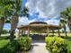Outdoor picnic gazebo with multiple picnic tables for relaxing and enjoying shade on a sunny day at 16043 Pebble Bluff Loop, Winter Garden, FL 34787