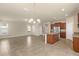 Open floor plan kitchen featuring a large island, stainless appliances, and tile flooring at 16043 Pebble Bluff Loop, Winter Garden, FL 34787