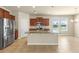 Open kitchen boasts a granite island, stainless steel appliances, and tile flooring at 16043 Pebble Bluff Loop, Winter Garden, FL 34787