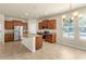 Open kitchen boasts a granite island, stainless steel appliances, and tile flooring at 16043 Pebble Bluff Loop, Winter Garden, FL 34787