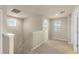 Bright upstairs landing with stairs, carpeted floors, natural light, and neutral walls at 16043 Pebble Bluff Loop, Winter Garden, FL 34787