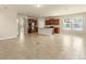 Open concept living area with a kitchen island, tile floors, and plenty of natural light at 16043 Pebble Bluff Loop, Winter Garden, FL 34787