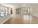 Open concept living area with a kitchen island, tile floors, and sliding glass doors at 16043 Pebble Bluff Loop, Winter Garden, FL 34787