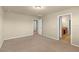 Carpeted main bedroom featuring an ensuite bathroom and a closet at 16043 Pebble Bluff Loop, Winter Garden, FL 34787