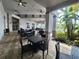 Covered outdoor seating area with tables, chairs, ceiling fans and a tropical setting at 16043 Pebble Bluff Loop, Winter Garden, FL 34787