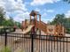 Neighborhood playground with slides, climbing area, and jungle gym with benches for parents and children at 16043 Pebble Bluff Loop, Winter Garden, FL 34787