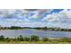 Peaceful water view of a pond surrounded by lush green vegetation and blue skies in the community at 16043 Pebble Bluff Loop, Winter Garden, FL 34787