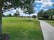 Scenic community walking path winding past a pond and lush green space, perfect for outdoor enjoyment at 16043 Pebble Bluff Loop, Winter Garden, FL 34787