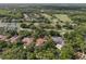 Aerial view of the property nestled among mature trees and overlooking the golf course at 1716 Greystone Ct, Longwood, FL 32779