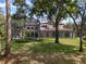 View of the house from the backyard, with screened pool enclosure at 1716 Greystone Ct, Longwood, FL 32779