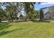 Expansive backyard with mature trees and a screened enclosure for outdoor enjoyment at 1716 Greystone Ct, Longwood, FL 32779