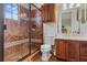 Bathroom featuring a glass enclosed shower with mosaic tile accents and wood vanity at 1716 Greystone Ct, Longwood, FL 32779